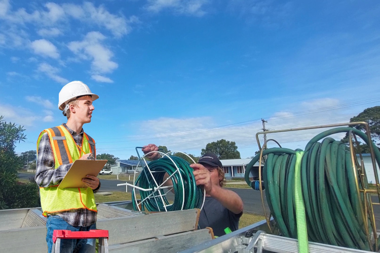 
Gutter cleaner in portstephens loads hoses following thorough gutter rinsing.